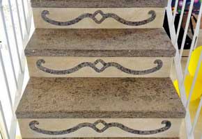Scala in peperino e travertino con sottogradi intarsiati